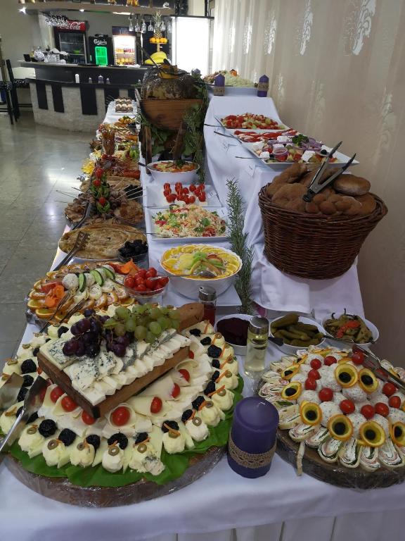 a table filled with lots of different types of food at Hotel Royal Drina in Mali Zvornik