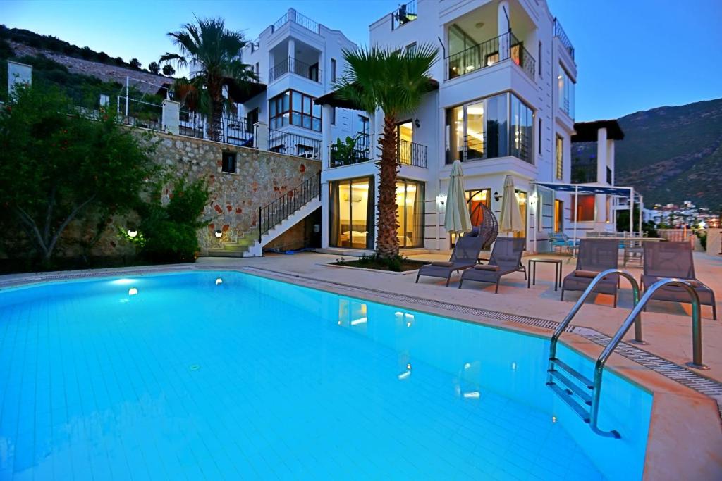 a large swimming pool in front of a house at Villa Asya in Kalkan
