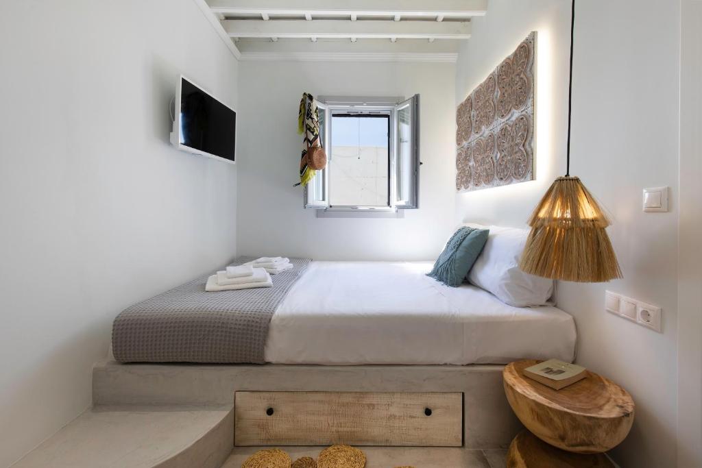 A bed or beds in a room at Thalassa Luxury Studios Lindos