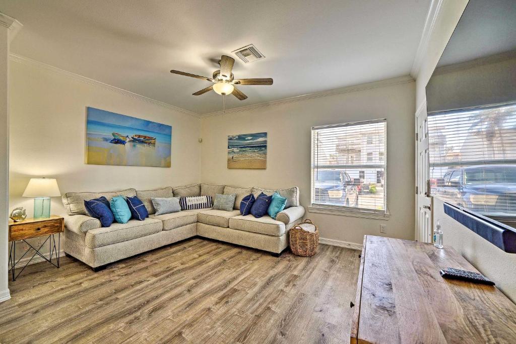 a living room with a couch and a ceiling fan at Modern Island Condo with Pool Steps to the Beach! in South Padre Island
