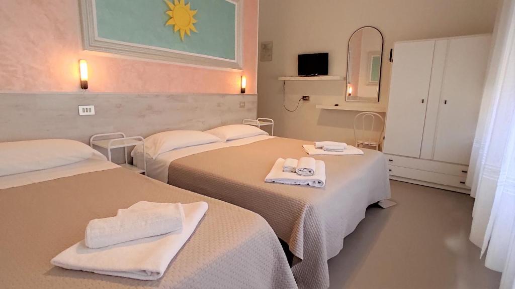 Postel nebo postele na pokoji v ubytování Hotel De Amicis