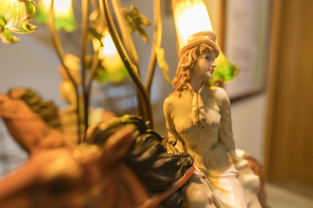a figurine of a woman sitting on a horse at Lantern Guest House in Marsalforn