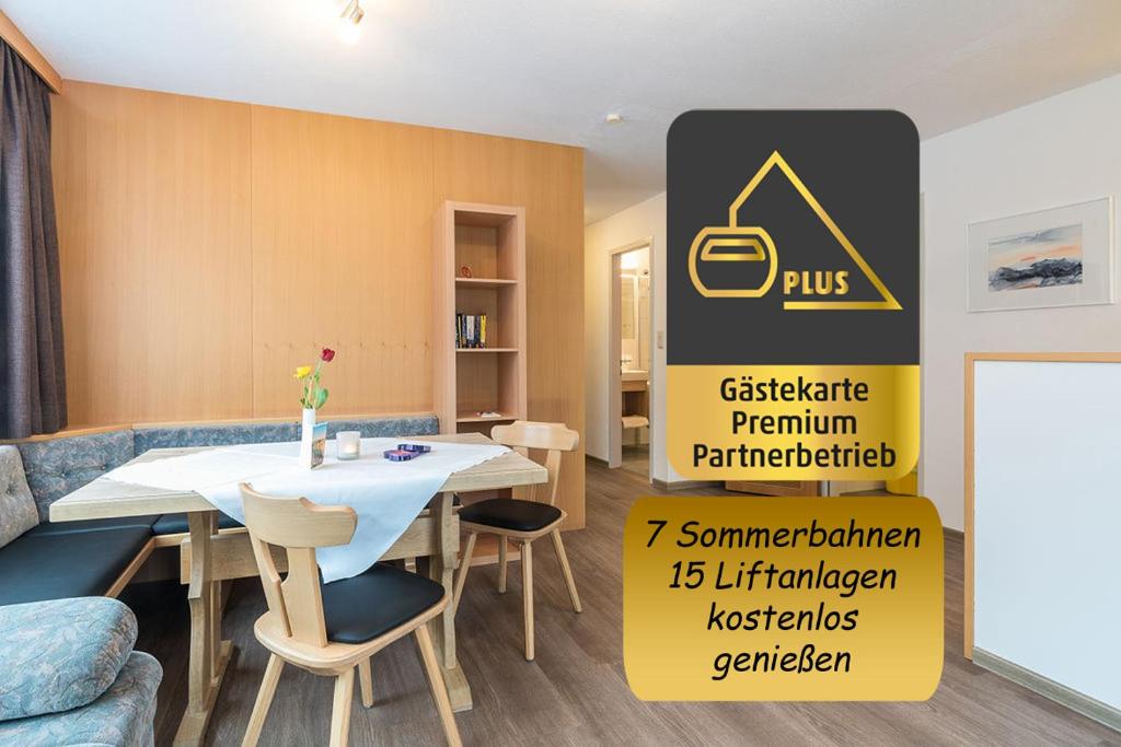a dining room with a table and chairs and a sign at Appartement Haus Zalim in Brand