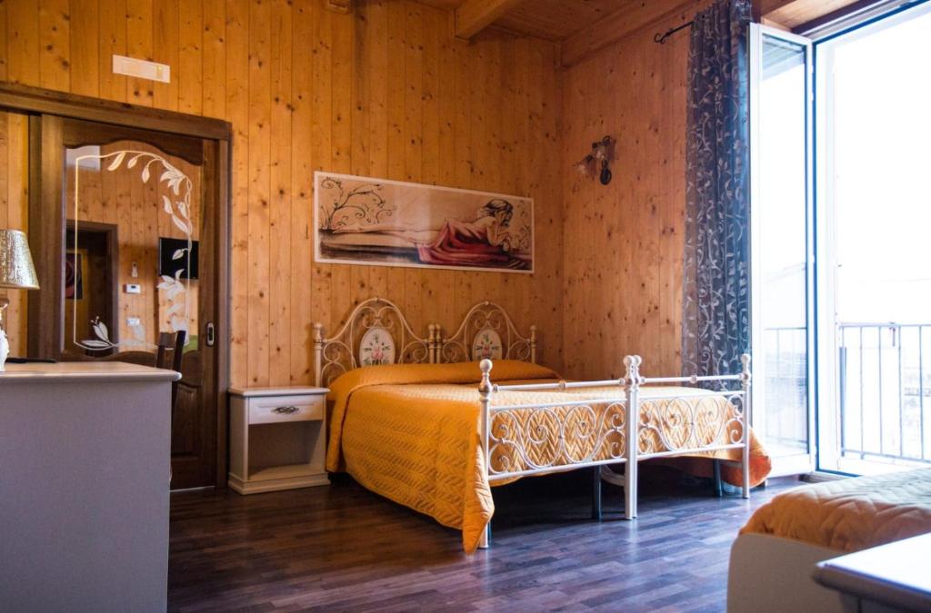a bedroom with a bed in a room with wooden walls at La Teresa B&B in Copertino