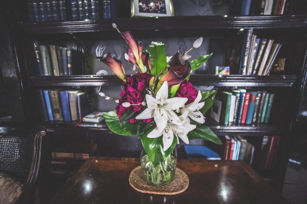 a vase filled with flowers sitting on a table at Jeakes House in Rye