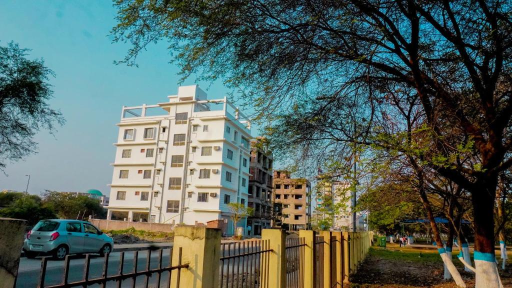 a white building with a fence in front of it at The Bliss in Kolkata