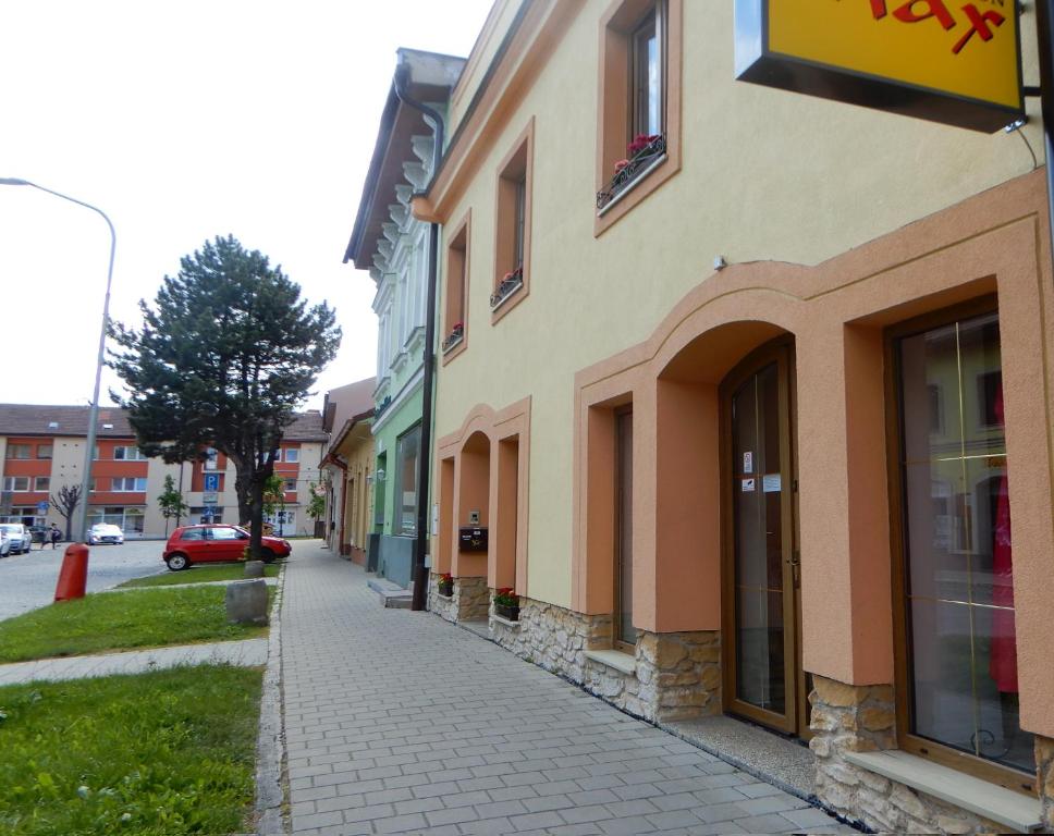 a sidewalk next to a building on a street at Penzión Max in Kežmarok