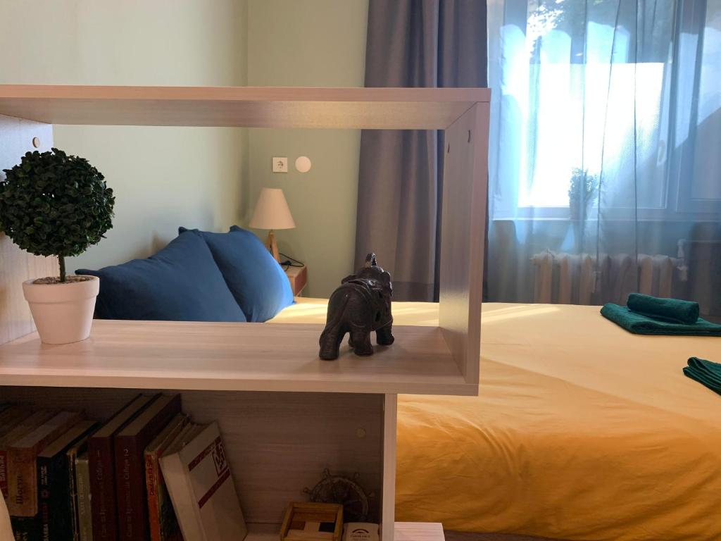a toy elephant sitting on a bed in a bedroom at Exceptional Refurnished Studio TOP Location in Sofia