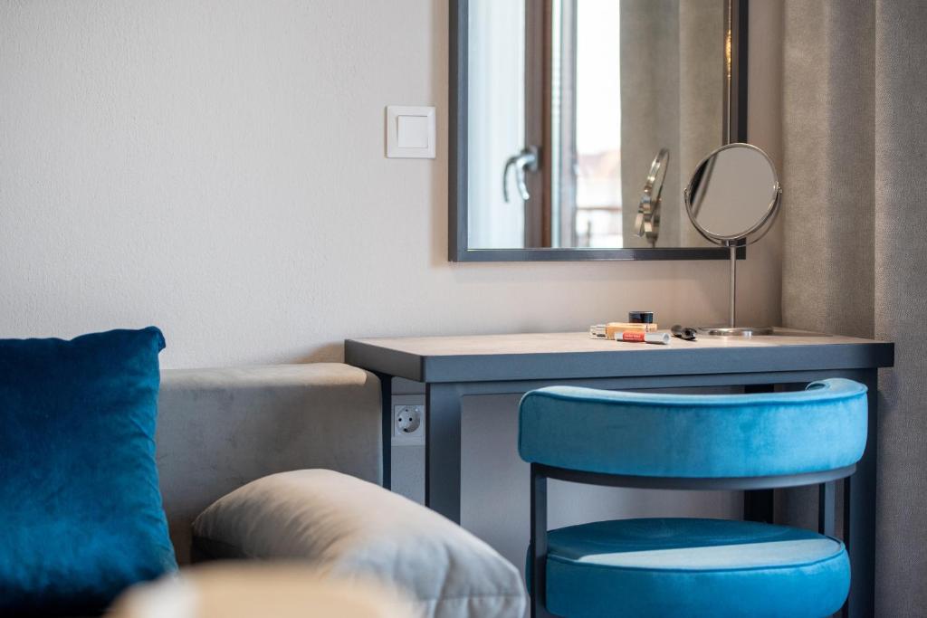 a bathroom with a blue stool next to a sink at VagAthan - Lux Holidays in Afitos