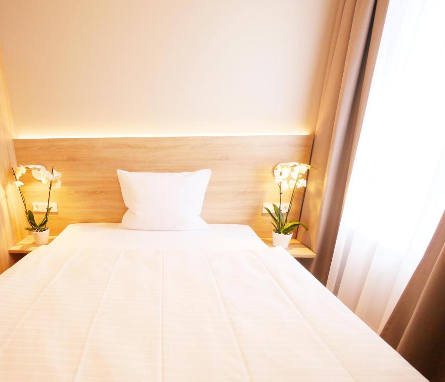 Postel nebo postele na pokoji v ubytování KELKO 1A Hotel