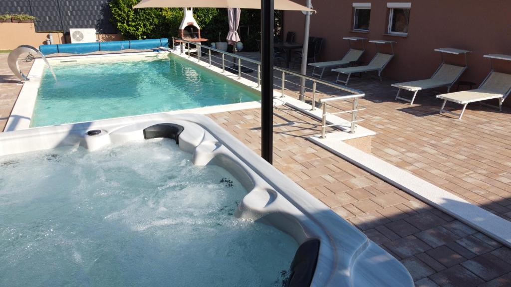 a large pool with a hot tub in a hotel at Villa Dalmatian in Sveti Petar