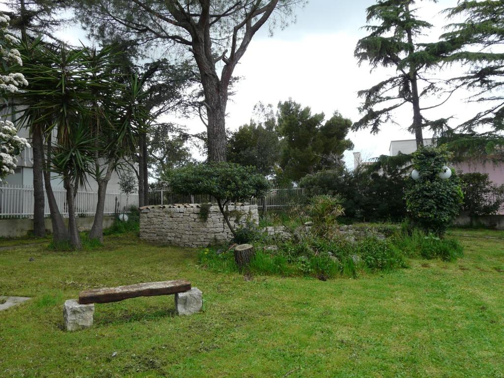 a park with a bench in the grass at B&B Villa Garden in Bisceglie