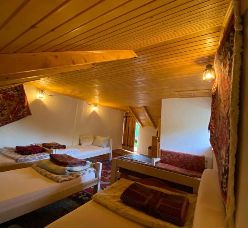 a attic room with two beds and a table at Etno-house Lukomir in Lukomir