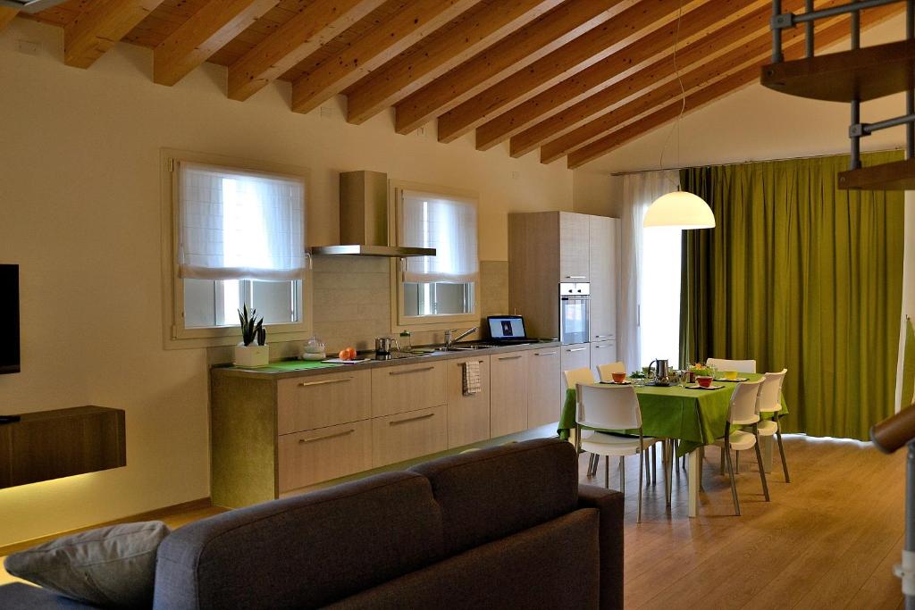 a kitchen and living room with a couch and a table at Residenze Cà Fabris in Romano D'Ezzelino