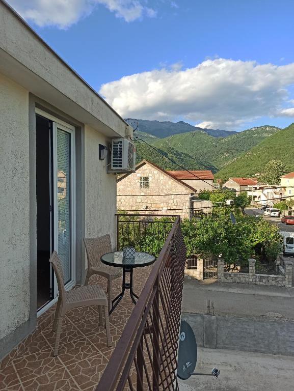 a patio with a table and chairs on a balcony at Lastva Holliday Rooms in Budva