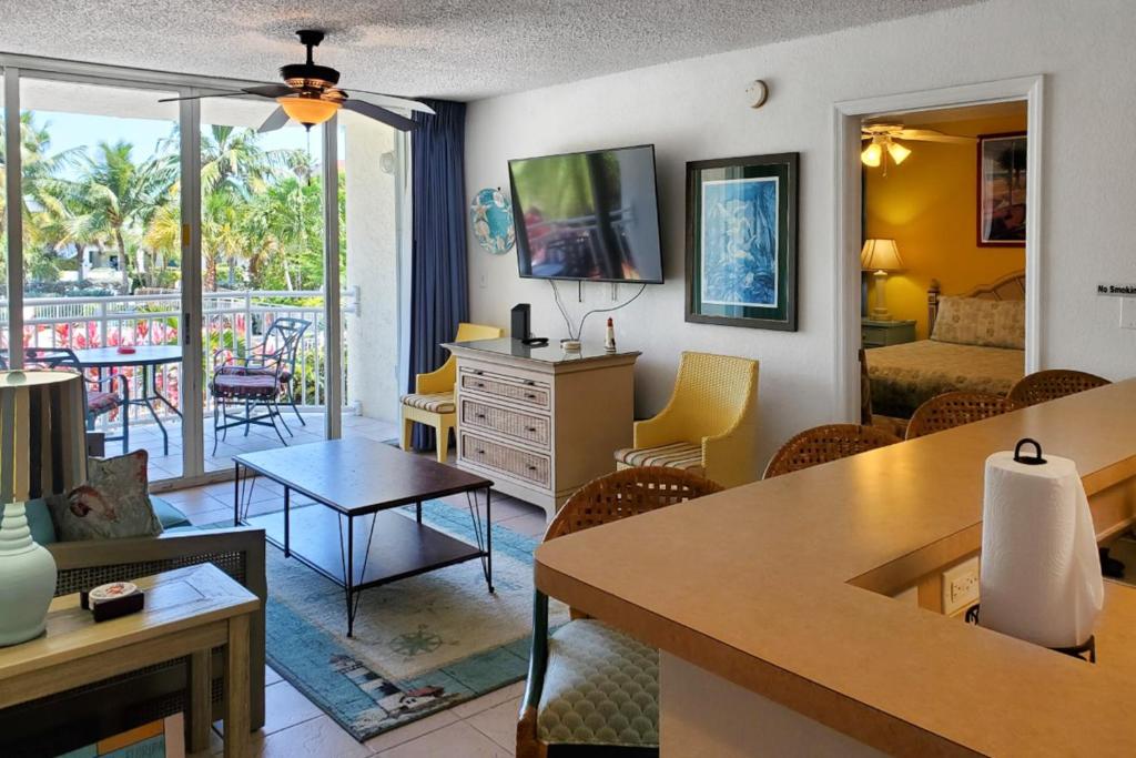 a living room with a bedroom and a living room at Sunrise Suites - Butterfly Nest #107 in Key West