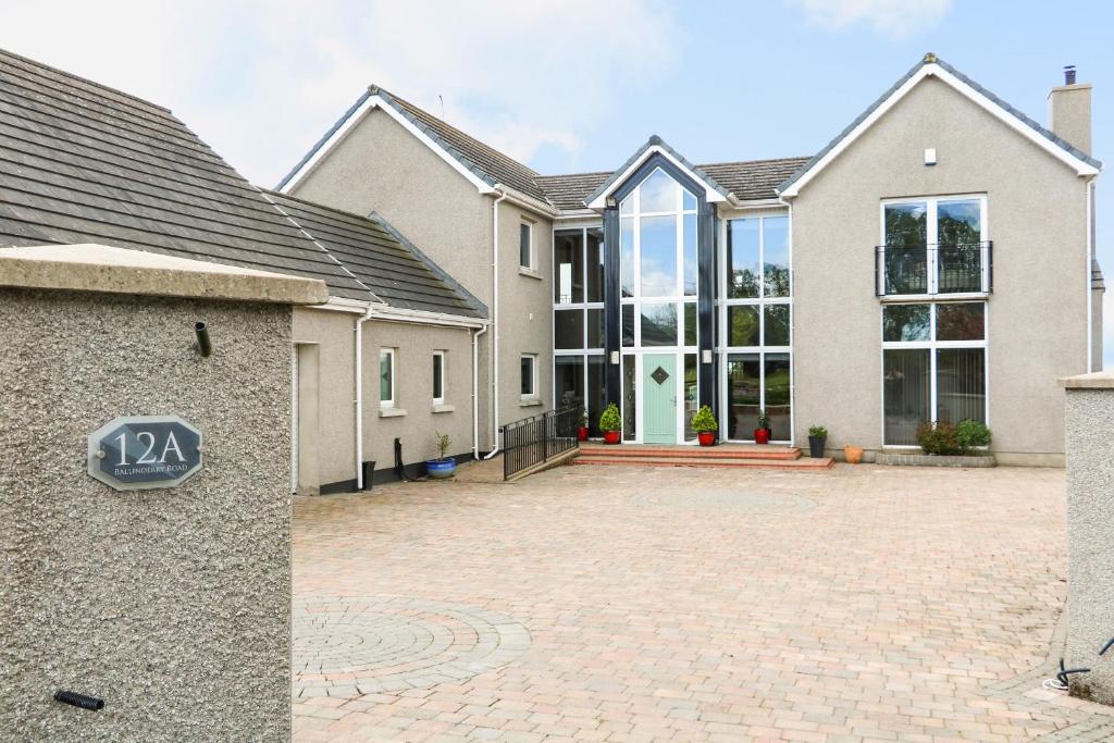 una casa grande con una entrada delante de ella en Red Robin's Annex en Craigavon