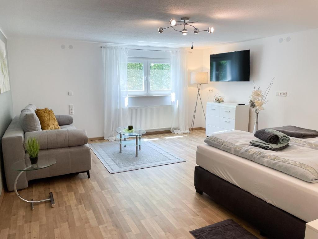 a living room with a bed and a couch at Ferienwohnung Esther in Singen