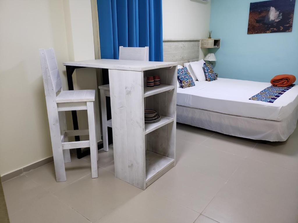 Postel nebo postele na pokoji v ubytování Mustique Suites Curacao