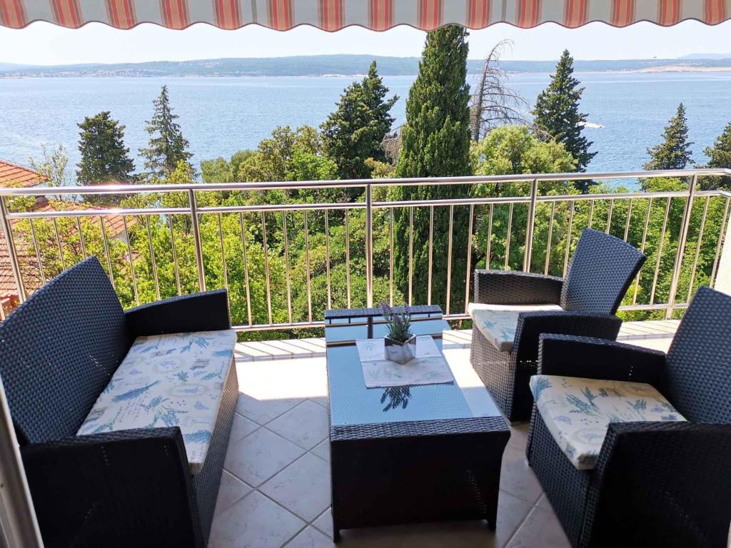 a patio with chairs and a table on a balcony at Apartment in Crikvenica 5739 in Dramalj