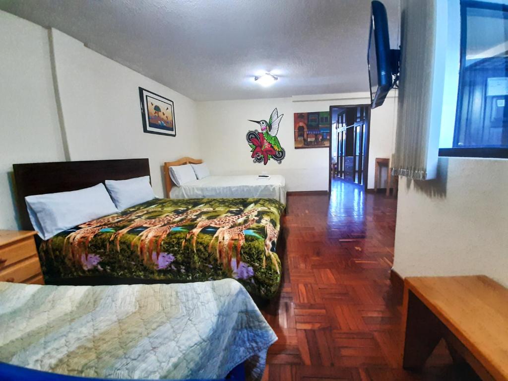 Postel nebo postele na pokoji v ubytování Hostal Monte Carmelo