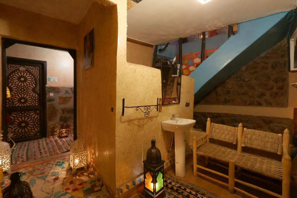 a bathroom with a sink and a staircase in a room at Toubkal Garden in Imlil
