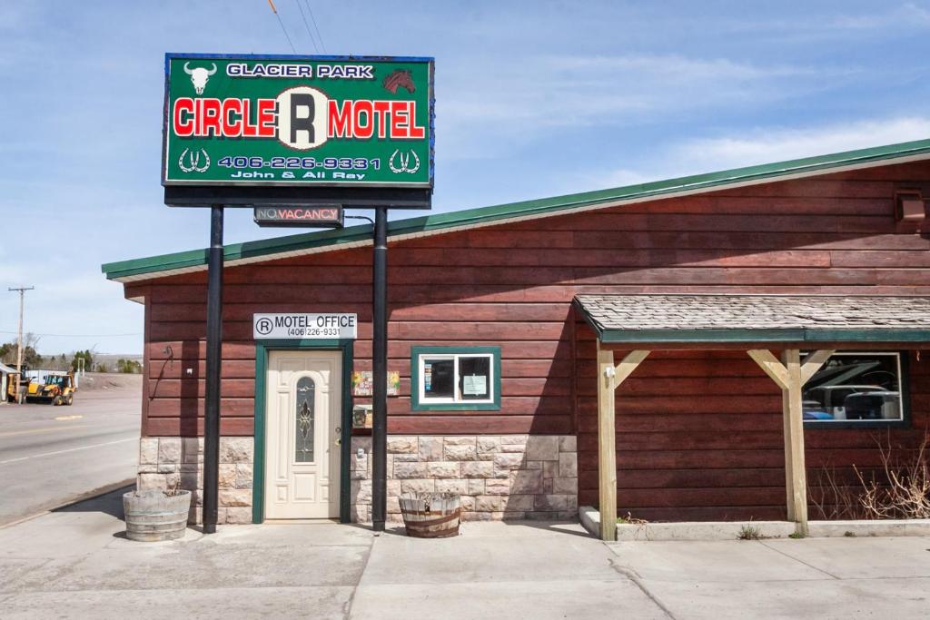 a sign for a circle o motel in front of a building at Circle R Motel in East Glacier Park