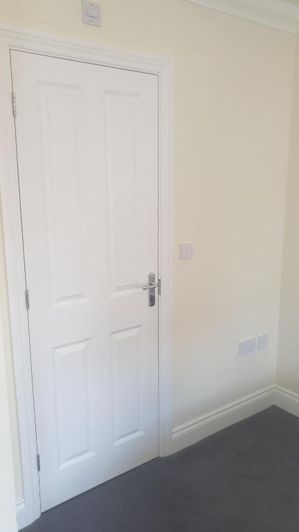 a white closet with a door in a room at SUNSHINE ROOM in Colchester