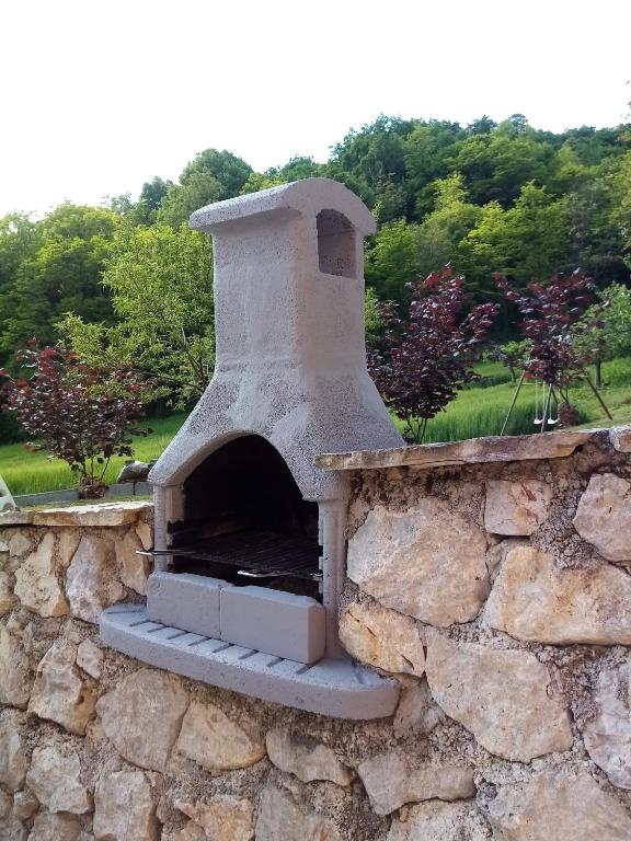 an outdoor pizza oven on a stone wall at Apartman Potocki in Krapina