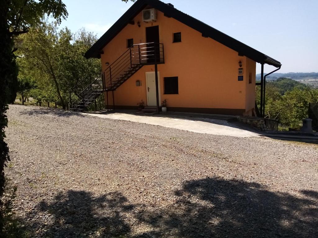 a house with a staircase on the side of it at Apartman Potocki in Krapina