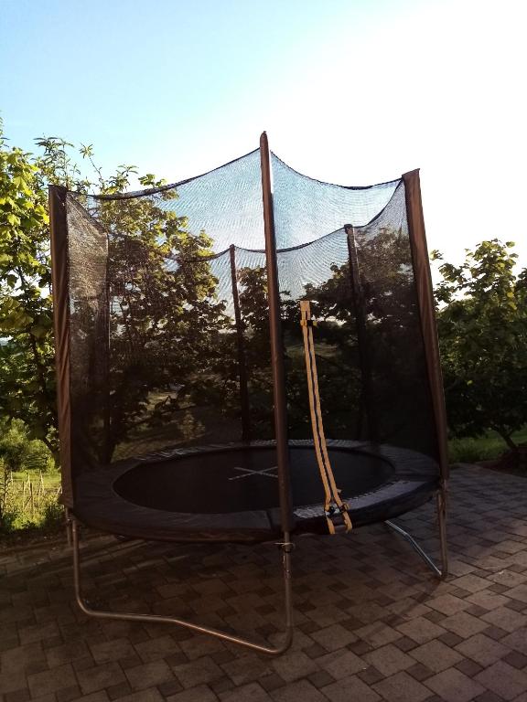 a glass enclosure with a trampoline on a patio at Apartman Potocki in Krapina