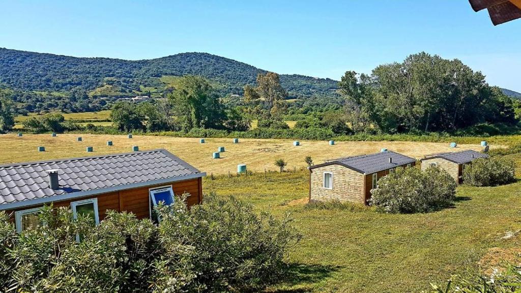 a small house in the middle of a field at Ferme de Chiuni in Cargèse