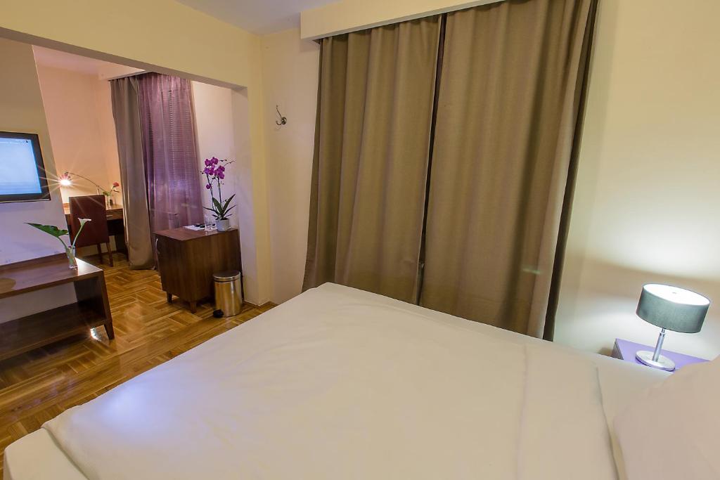 Postel nebo postele na pokoji v ubytování Hotel M
