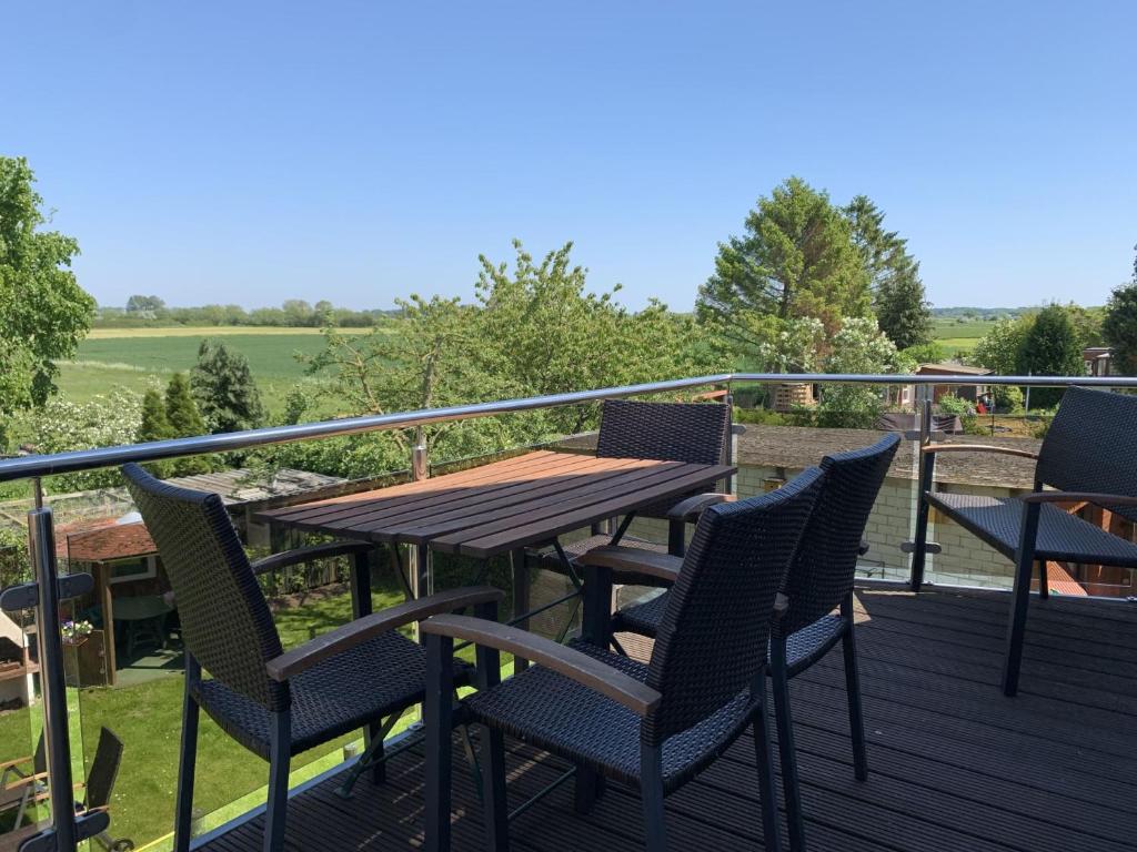 a wooden table and chairs on a deck at Horizont in Grube