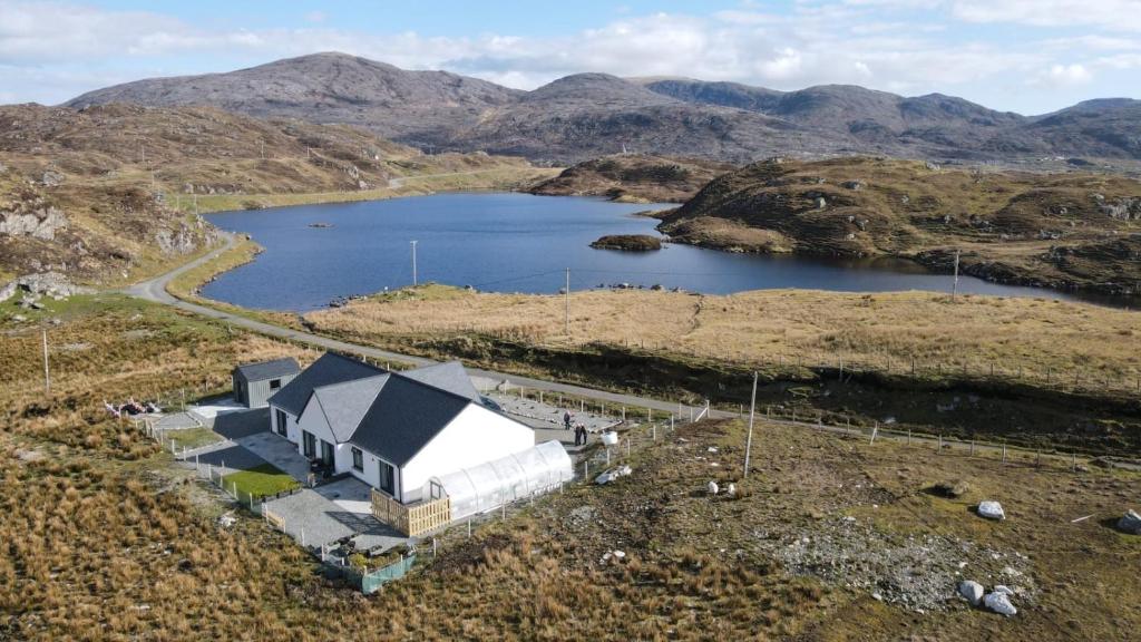 an aerial view of a house on a hill with a lake at Dunarain Bed & Breakfast in Tarbert