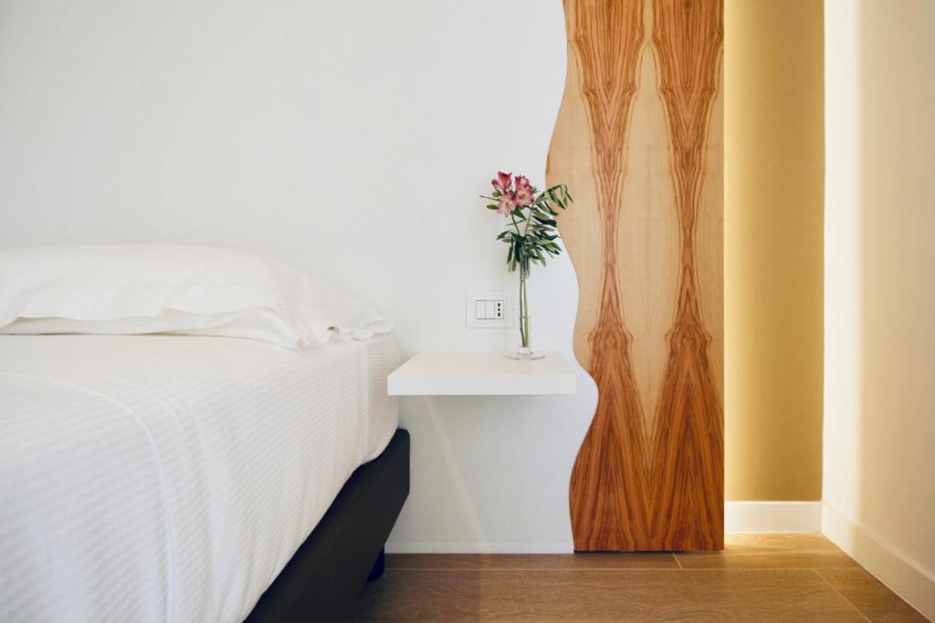 A bed or beds in a room at Hotel Olivò