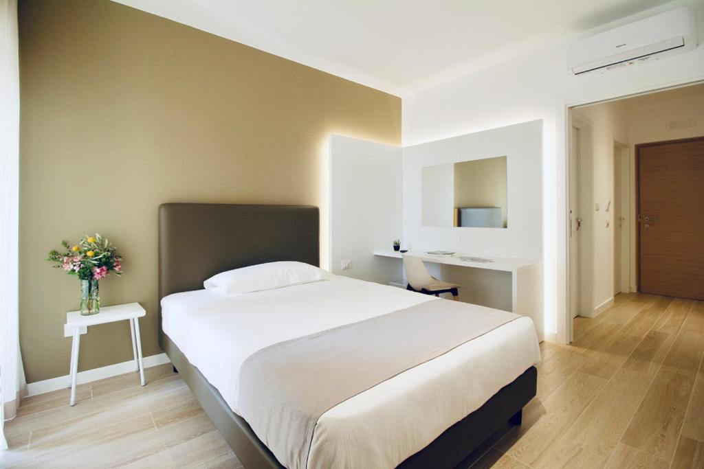 A bed or beds in a room at Hotel Olivò