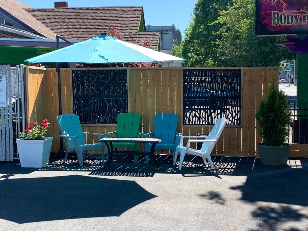 a patio with chairs and a table and an umbrella at Signature Inn Eugene in Eugene
