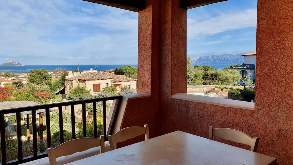 a balcony with a table and a view of the ocean at Fiordaliso Aurora in Olbia