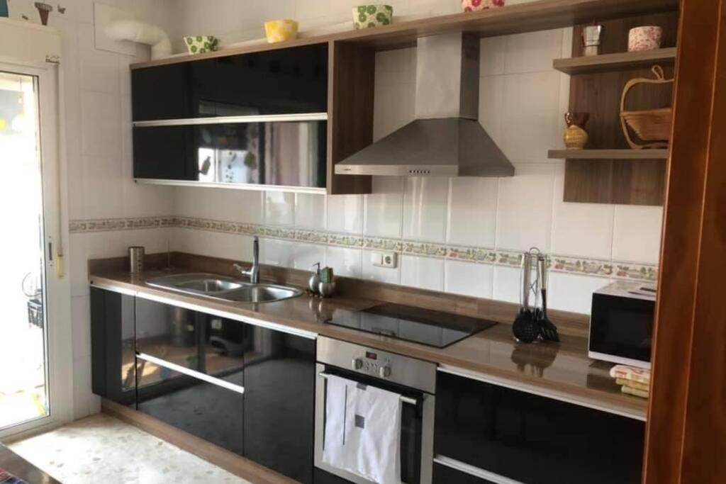 a kitchen with a sink and a stove at Apartamento en la playa in Adra