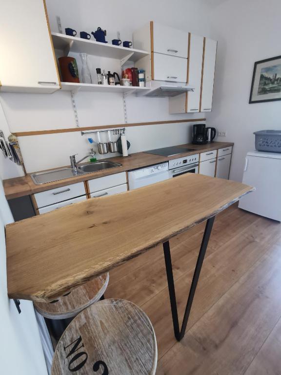 a kitchen with a wooden table and two chairs at Haus Nothnagl in Spitz