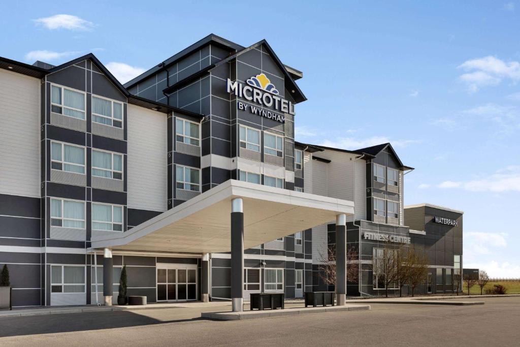 a rendering of the exterior of a hotel at Microtel Inn and Suites by Wyndham Weyburn in Weyburn