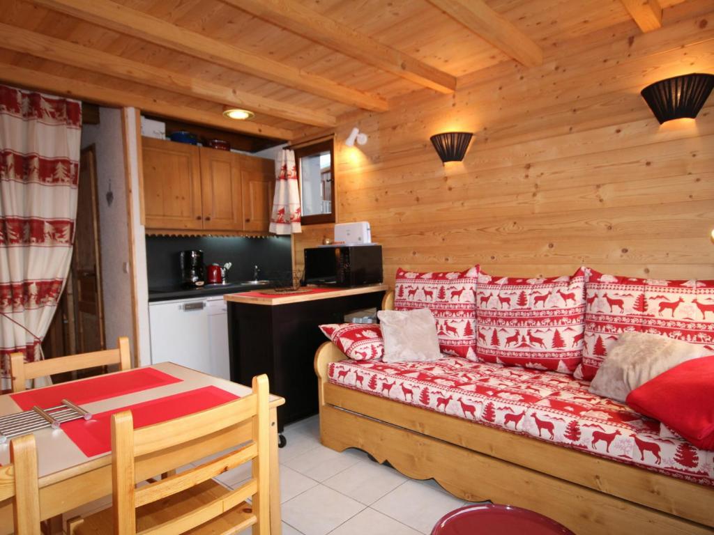 a room with a couch and a table and a kitchen at Appartement Les Saisies, 2 pièces, 5 personnes - FR-1-293-205 in Les Saisies