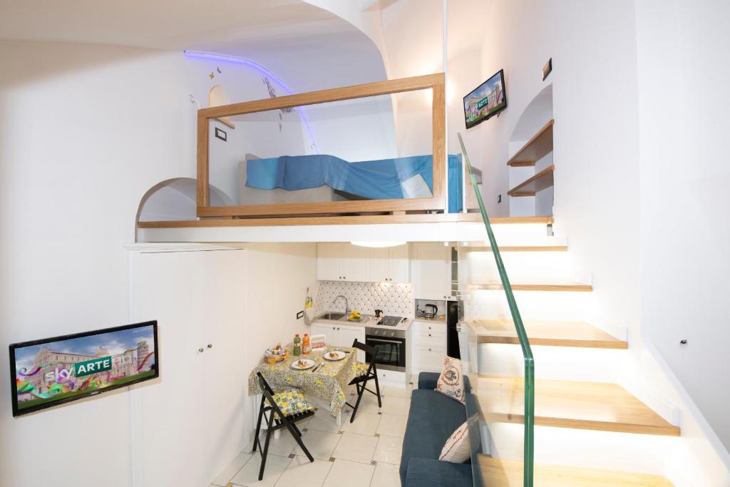 a room with a staircase and a living room at La dimora del nonno...nel cuore di Amalfi in Amalfi