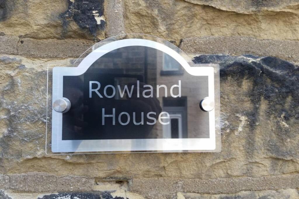 a sign on the side of a stone wall at Rowland House - Central Skipton, Dales Gateway in Skipton