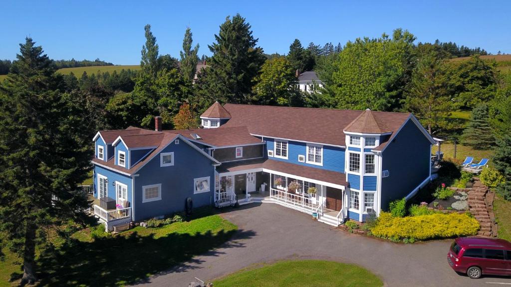 an aerial view of a large blue house at The Lookout Inn in New Glasgow