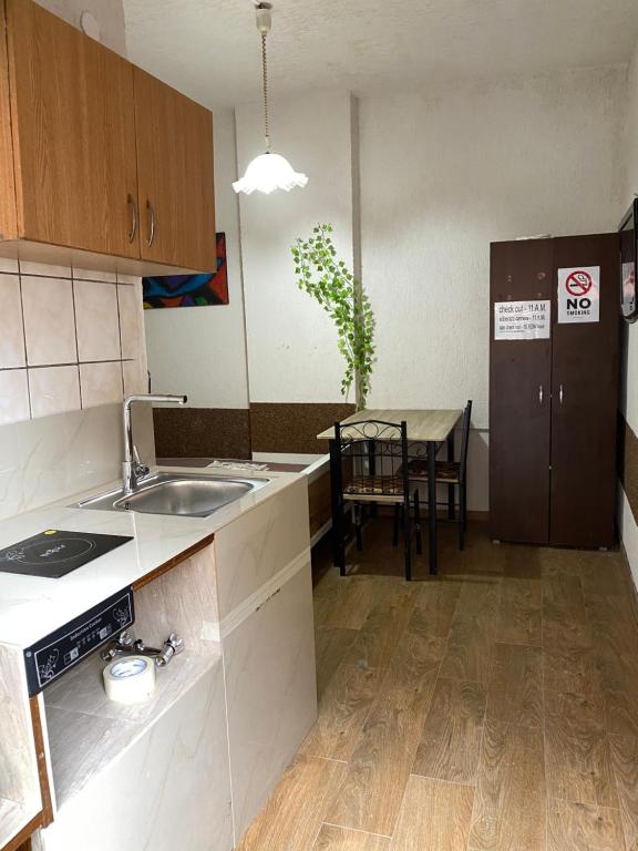 a kitchen with a sink and a table in it at 9 Mai Central Studio in Sibiu