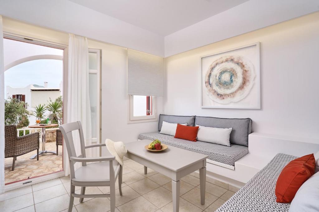 a living room with a couch and a table at Stelia Mare Boutique Hotel in Naousa