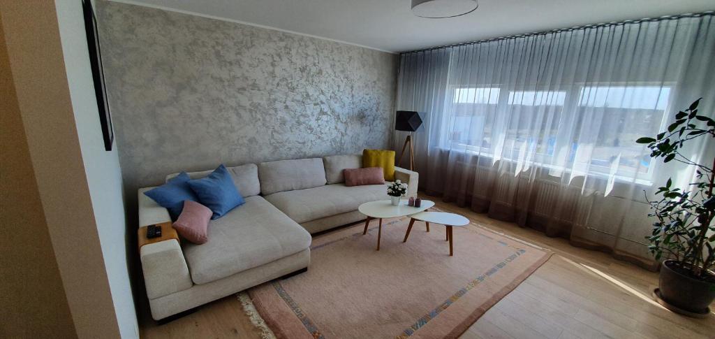 a living room with a couch and a table at Aia apartement in Kuressaare