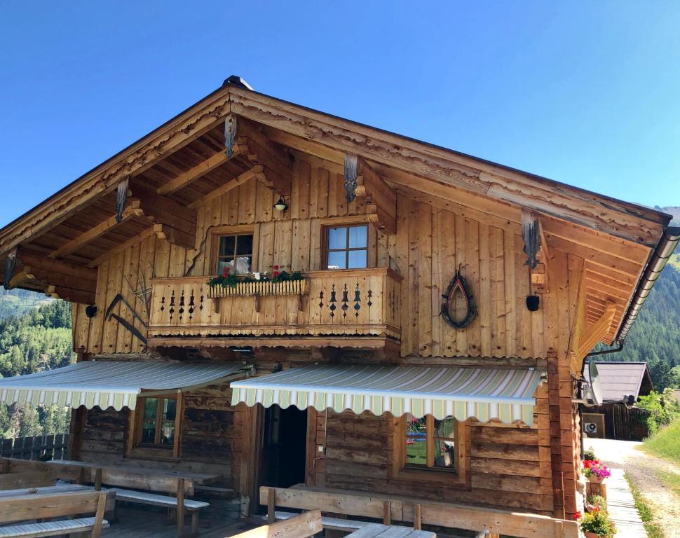 a log cabin with a balcony on the side of it at Hoamalm in Grossarl